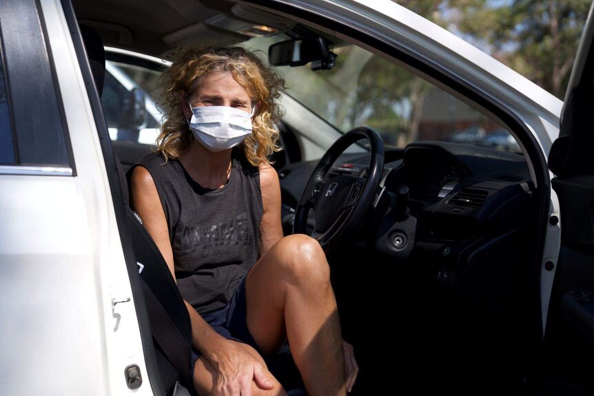 Bushfire evacuee Julia Stonehaven from Gidgeganup sits in her car.