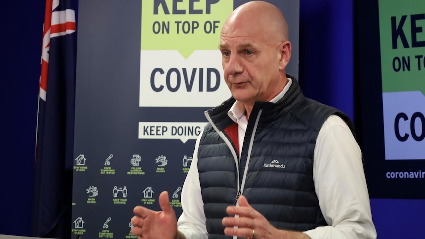 Close up of Premier Peter Gutwein, a man in a puffer vest with a bald head 