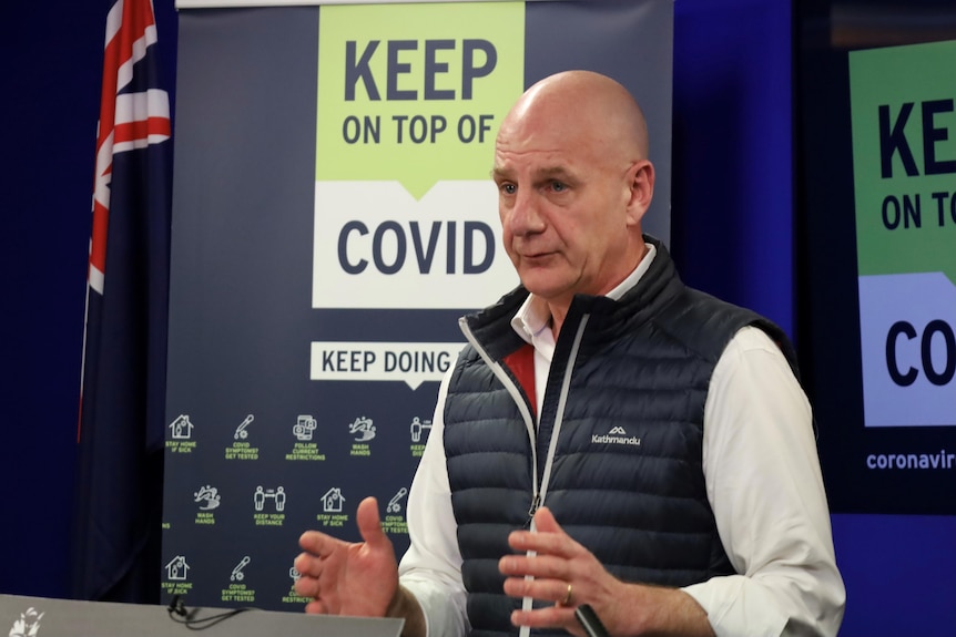 Close up of Premier Peter Gutwein, a man in a puffer vest with a bald head 