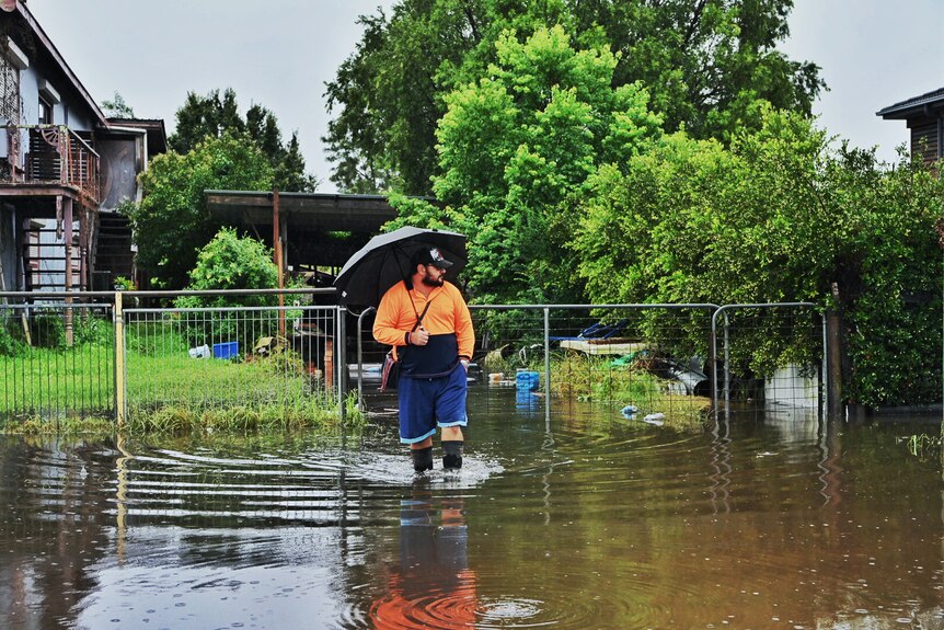 A man stands in floodwater