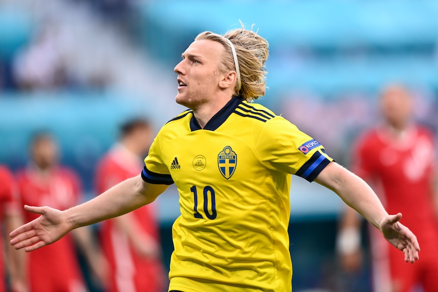 Emil Forsberg celebrates with his arms outstretched