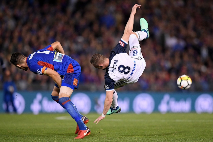 Besart Berisha in mid-air as he is tackled by Nigel Boogard.