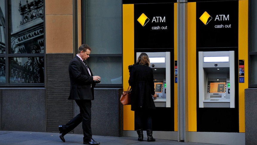 Customers use Commonwealth Bank ATMs