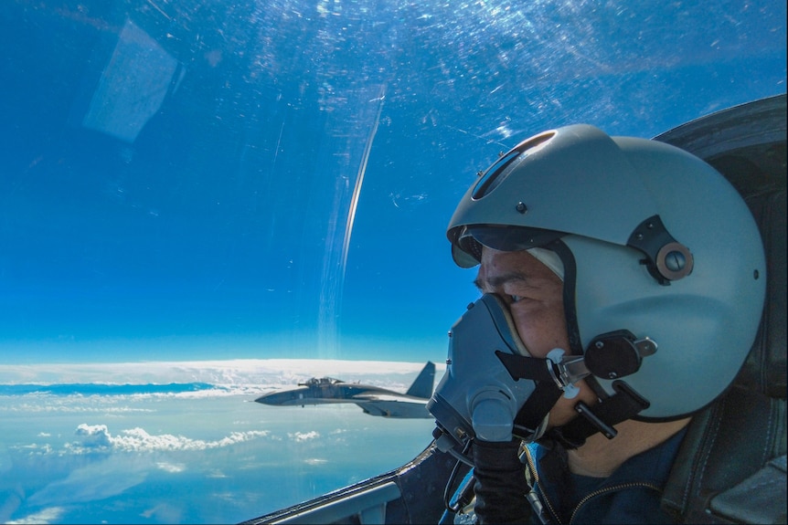 An air force pilot from PLA looks as they conduct a joint combat training exercises around the Taiwan Island