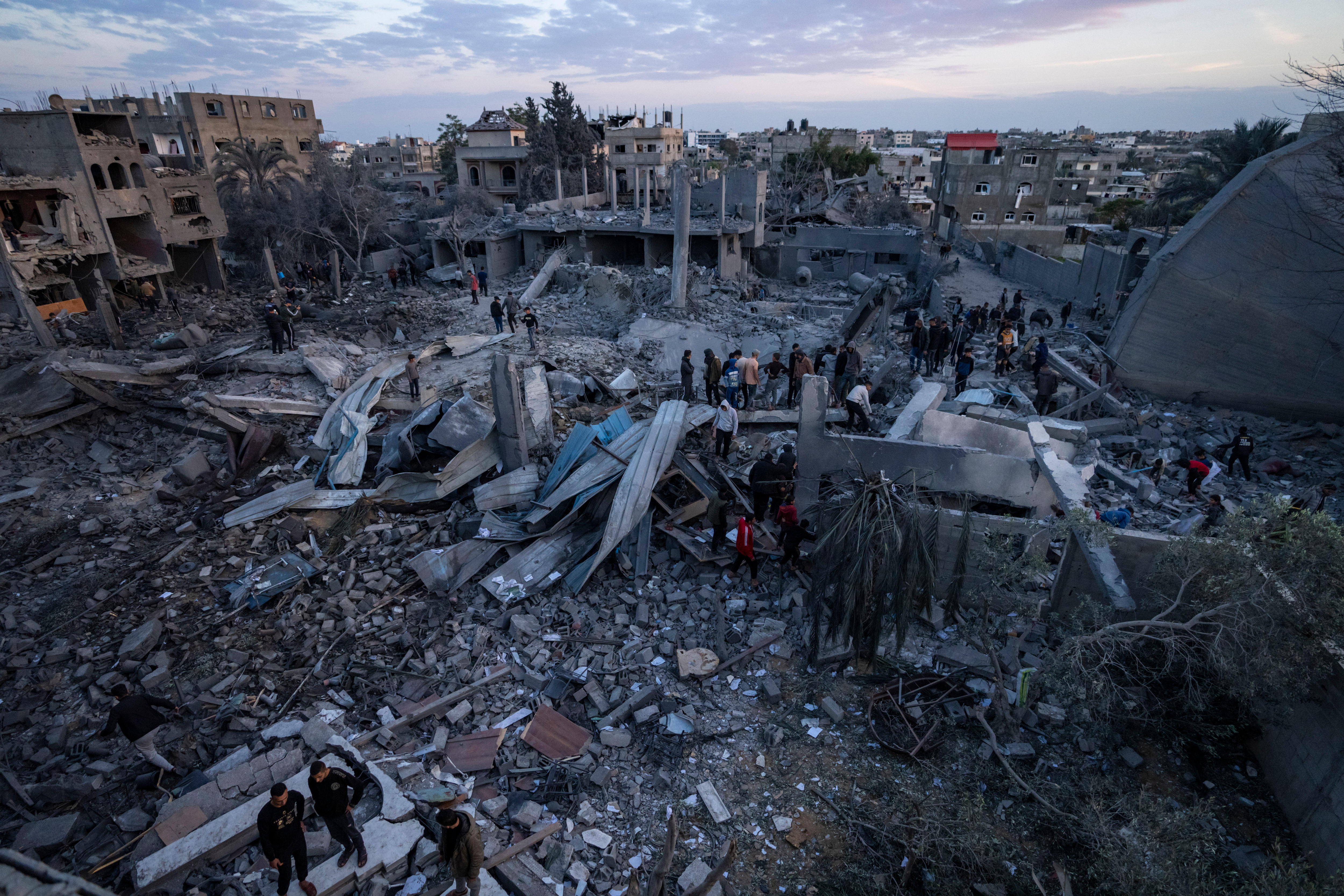 Palestinians look at a mosque destroyed in an Israeli strike in Rafah.