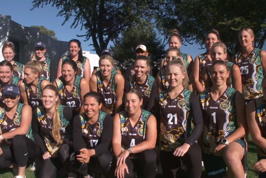 Group of female athletes in green, maroon jerseys