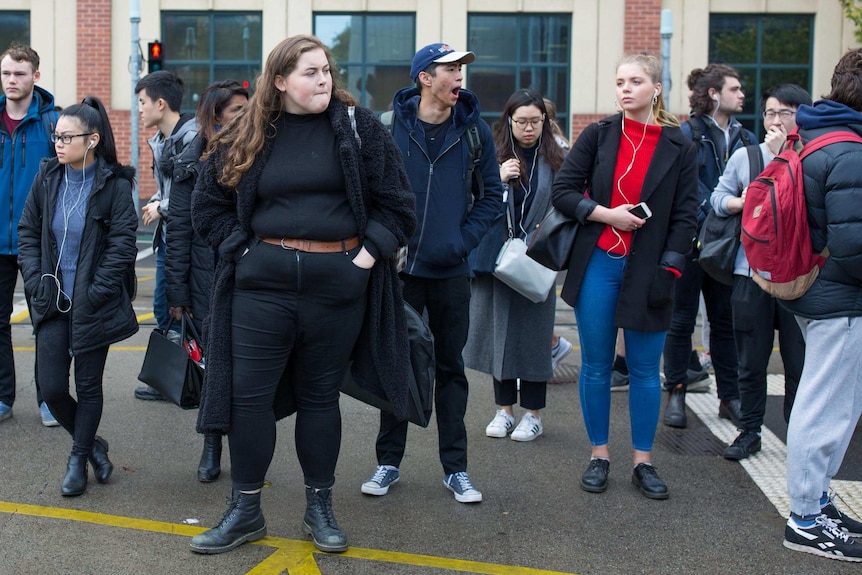 Molly Willmott waits on a platform for a train to take her to Melbourne University.