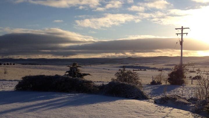 The sun rising over fields of white, just outside Cooma this morning.