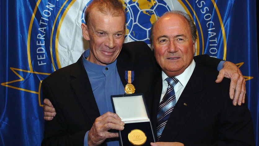 Johnny Warren receives the FIFA Centennial Order of Merit from Sepp Blatter in 2004.