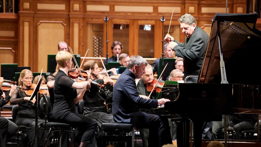 Stephen Hough at the piano, performing with the Adelaide Symphony Orchestra while Andrew Litton conducts.