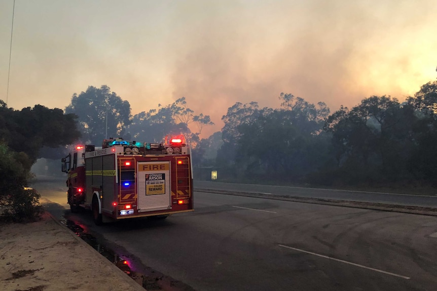 A fire truck on the side of the road at Kings Park in Perth with smoke covering the area.