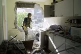 An Israeli rescue worker surveys the scene of a rocket attack in an northern Israeli city.