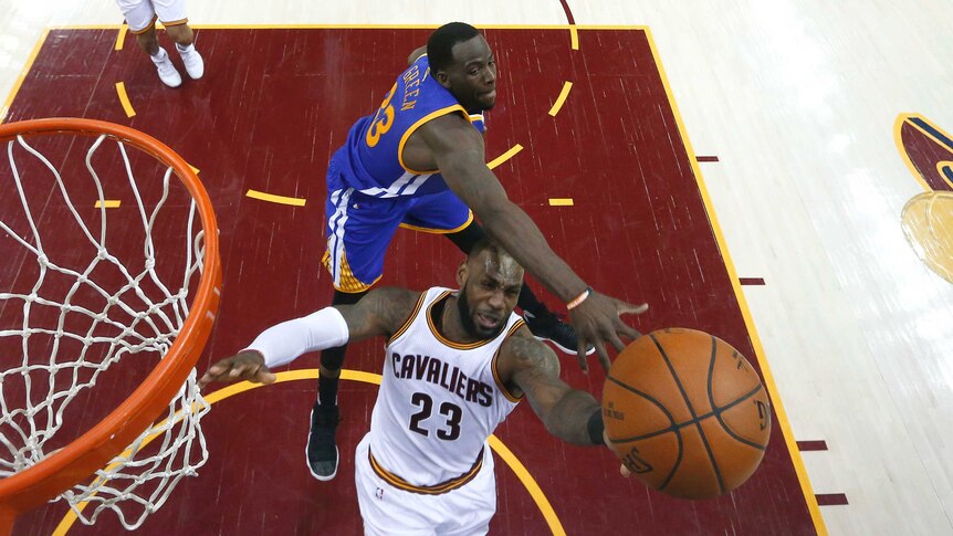 LeBron James is defended by Draymond Green