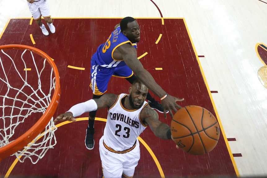 LeBron James is defended by Draymond Green