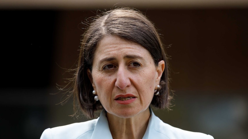 A woman in a pale blue blazer with a brown bob