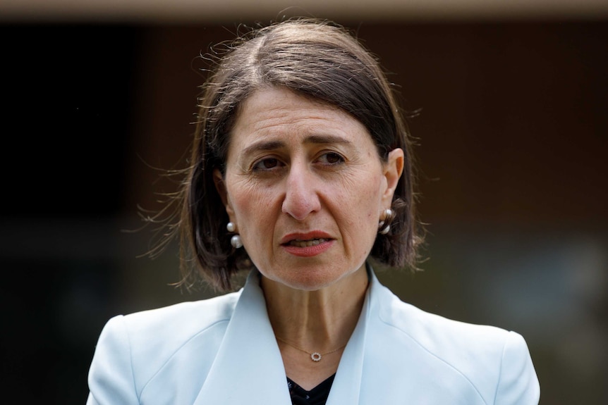 A woman in a pale blue blazer with a brown bob