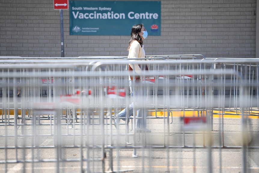 a person walking along a fence