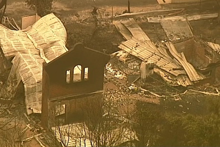 An aerial still shows Mallacoota buildings flattened and destroyed by bushfire.