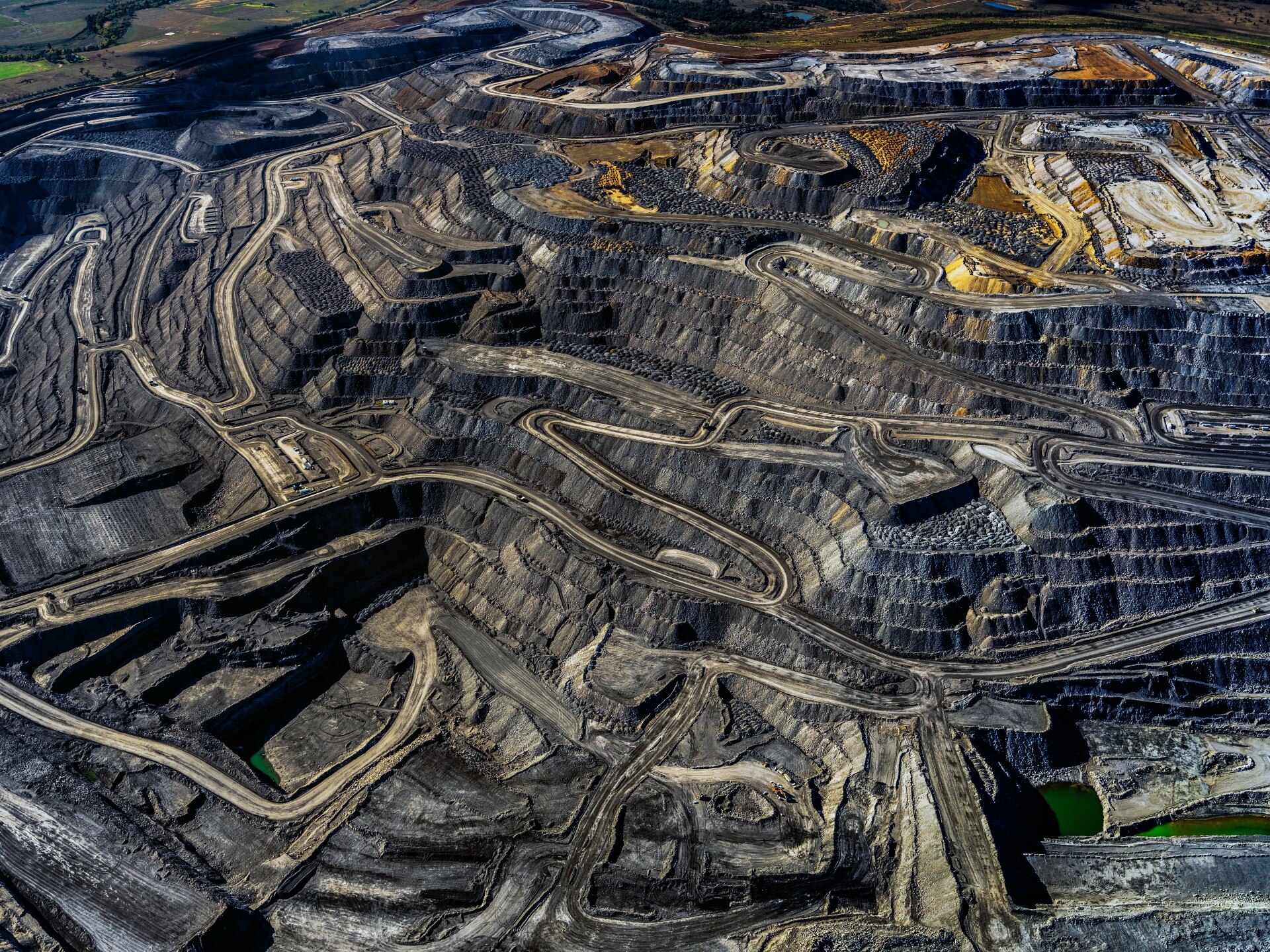 A huge coal mine pit with roads winding through it