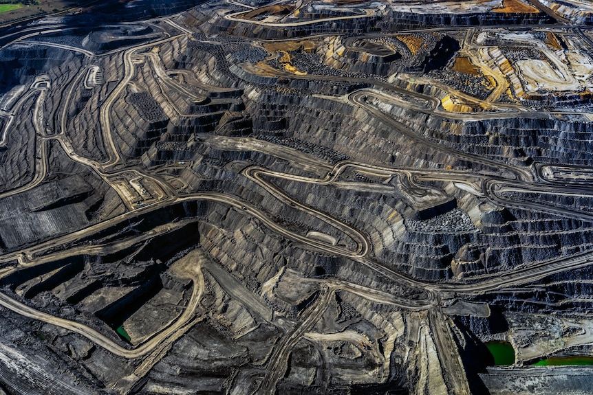 A huge coal mine pit with roads winding through it