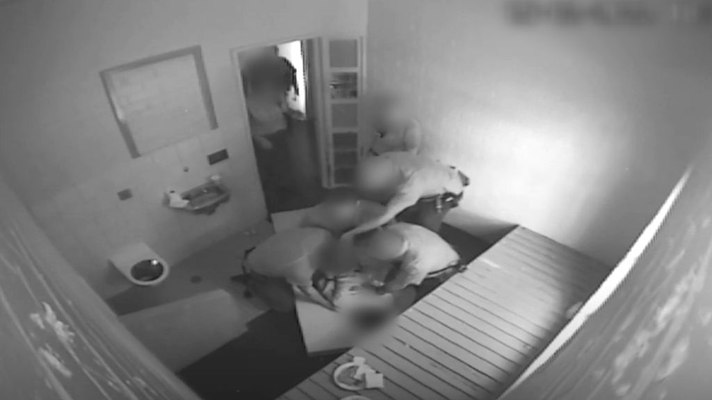 CCTV footage captures guards restraining the boy by 'folding' him.