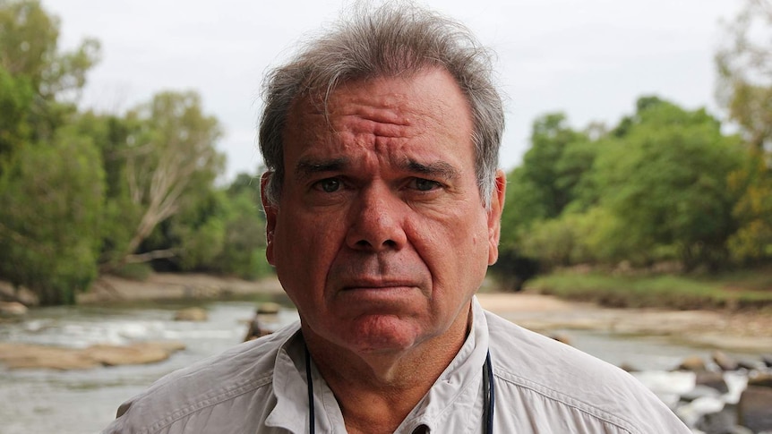 A close-up photo of Gary Lindner with Cahill's Crossing visible in the background.