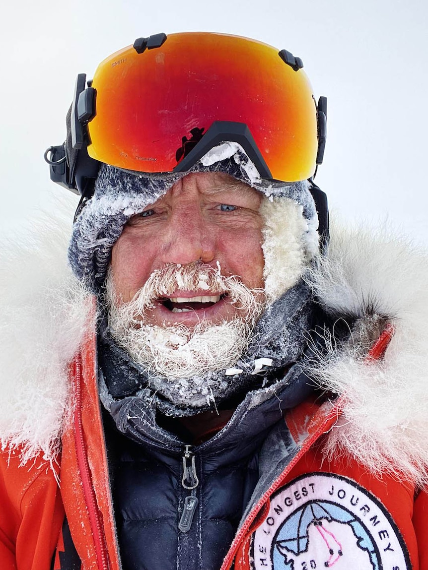 A man wearing snow goggles with an icy beard