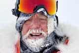 A man wearing snow goggles with an icy beard