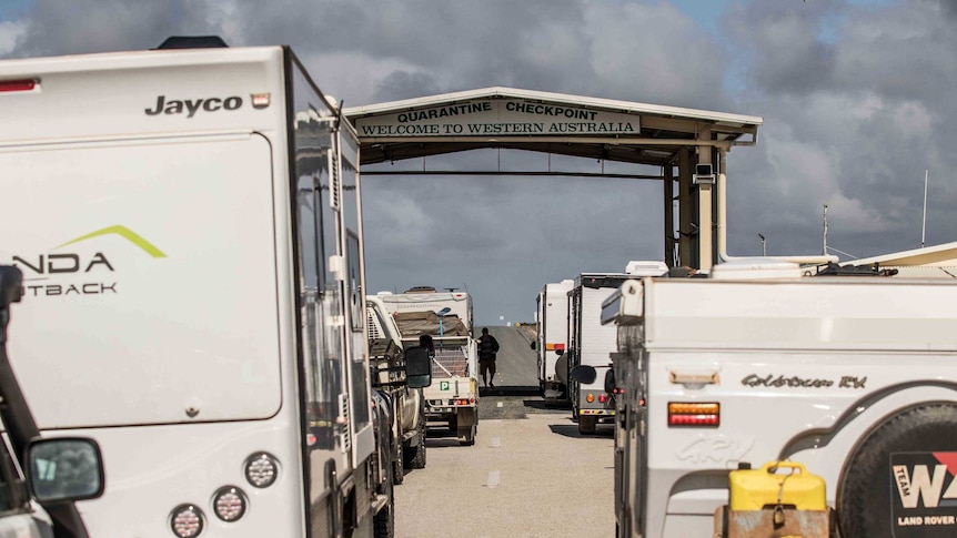 A line-up of cars, caravans and trucks at the West Australian border checkpoint at Eucla.