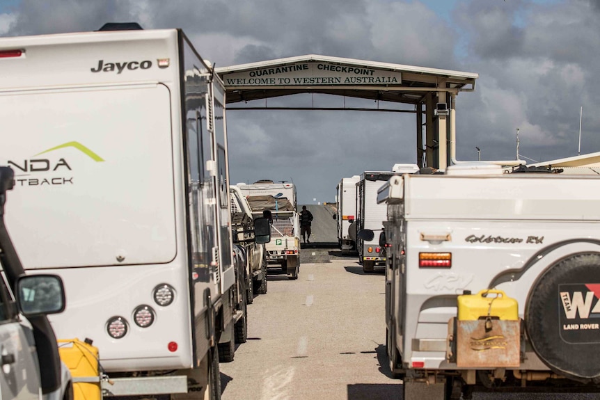 A line-up of cars, caravans and trucks at the West Australian border checkpoint at Eucla.