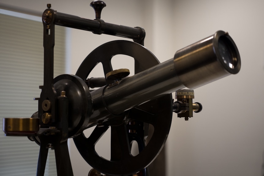 A theodolite surveying instrument on display.