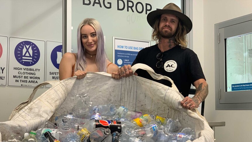 The couple with a giant bag full of plastic bottles.