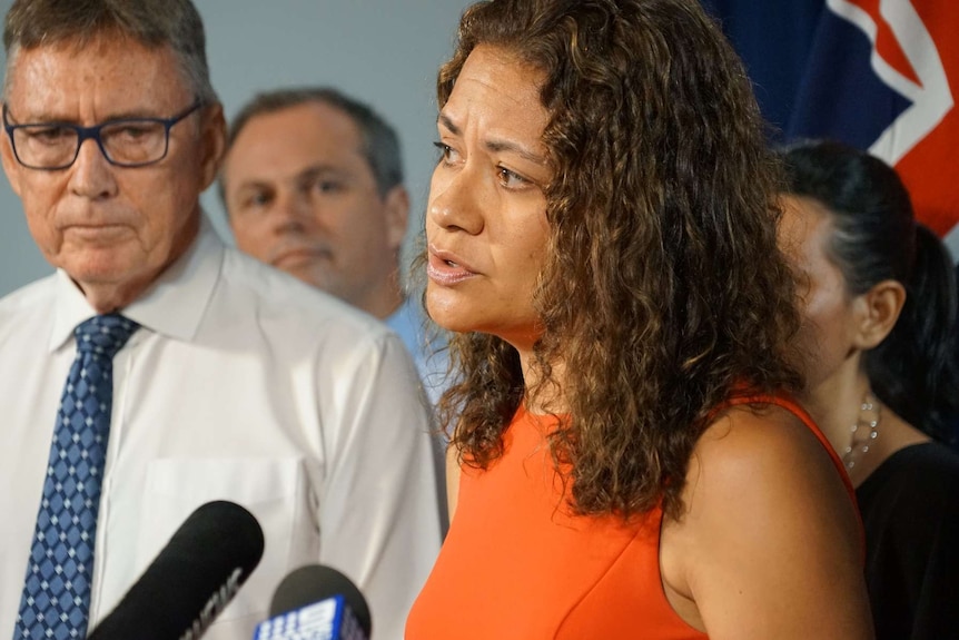 Amelia Nuku stands at a lectern.