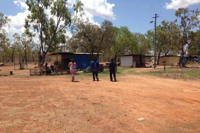 People stand outside the Mara Indigenous town camp.