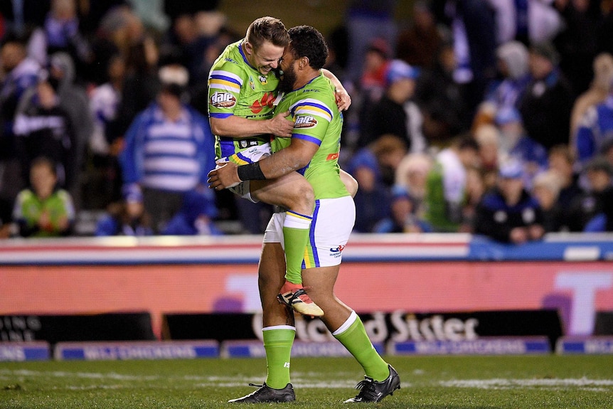 Sam Williams and Junior Paulo hug each other after the Raiders beat the Bulldogs.