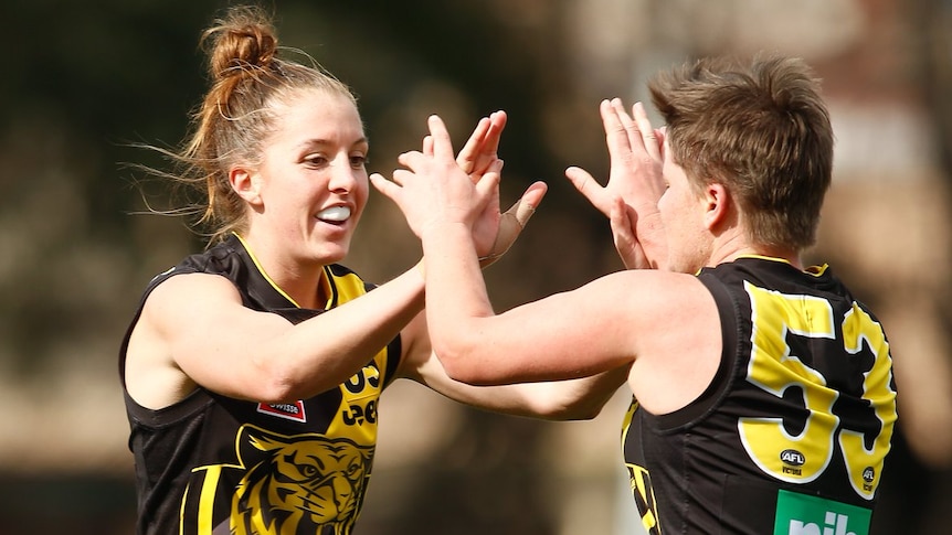 Two Richmond players celebrating during a VFLW match.