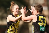 Two Richmond players celebrating during a VFLW match.