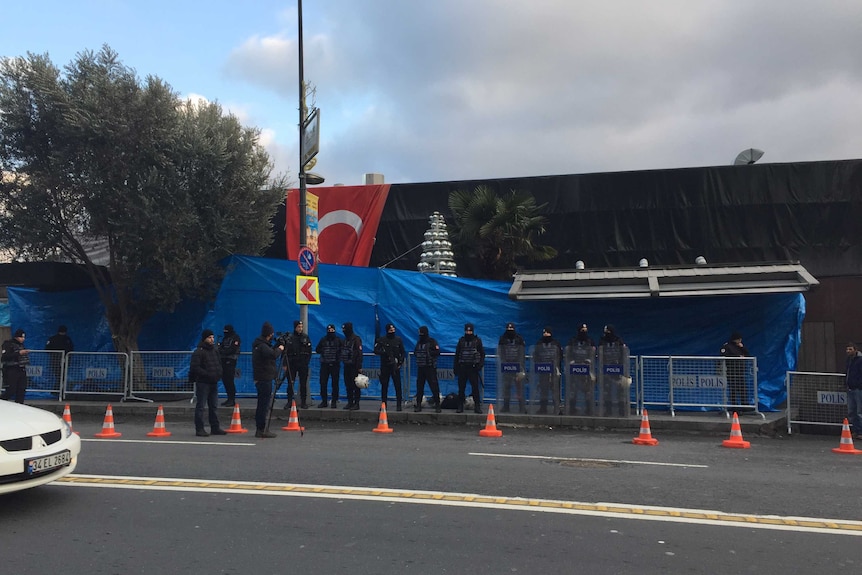 Police stand in front of a blue tarpaulin covering the front of the Reina nightclub, Istanbul.