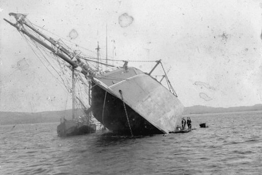 A ship lying beached in Careening Bay, 1880s