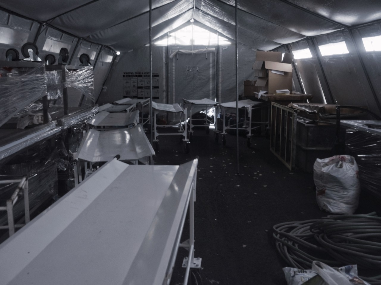 The interior of a tent with multiple benches in it