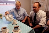 Boris Johnson pours Matt Hancock a cup of tea.