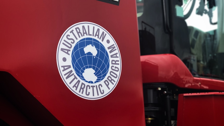 Close-up shot of the Australian Antarctic Program logo on a giant tractor.