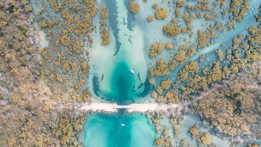 An aerial photo of the mouth of a river.