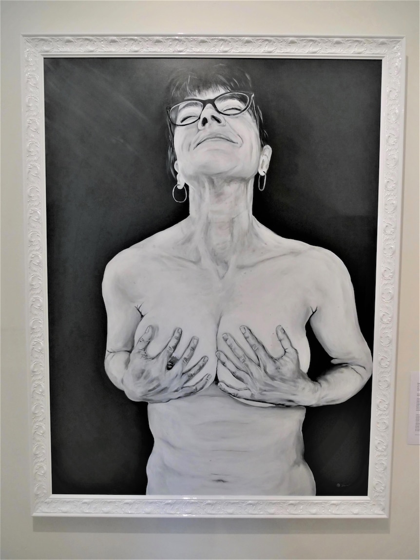 Black and white painting of a woman smiling as she holds her breasts.