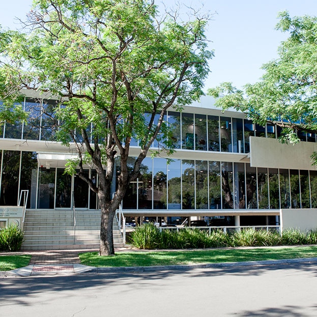 A two storey-office building with trees in front