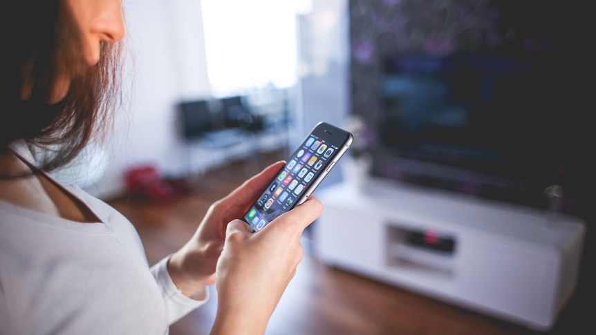 A woman using an iPhone