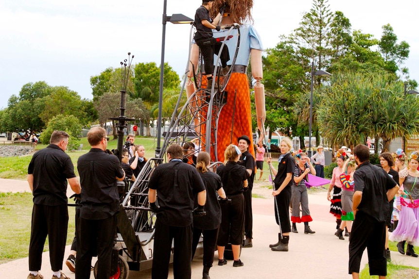 Volunteers helping to operate giant puppet Tilda