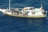 The boat carrying 54 passengers and two crew was intercepted by HMAS Albany yesterday.