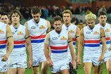 Western Bulldogs leave the field in low spirits during AFL loss to Adelaide Crows