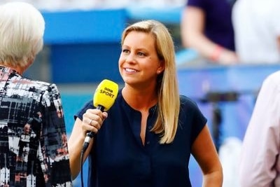A woman in a navy top interviews someone holding a yellow BBC Sport microphone.